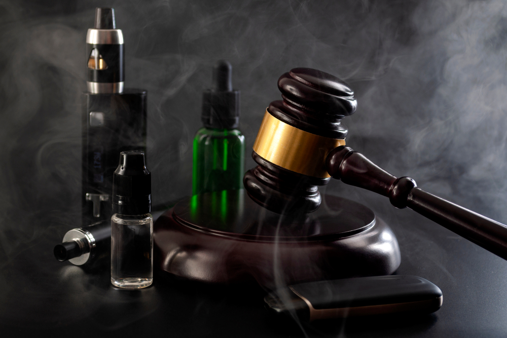 Image of a gavel and electronic devices for Vape Import Laws